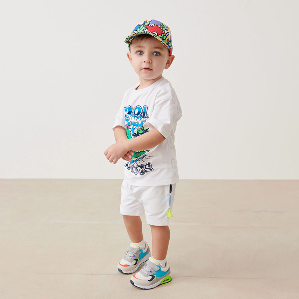 Baby boy wearing a dinosaur pattern short sleeve t-shirt clothing set, showcasing vibrant colors and playful design.