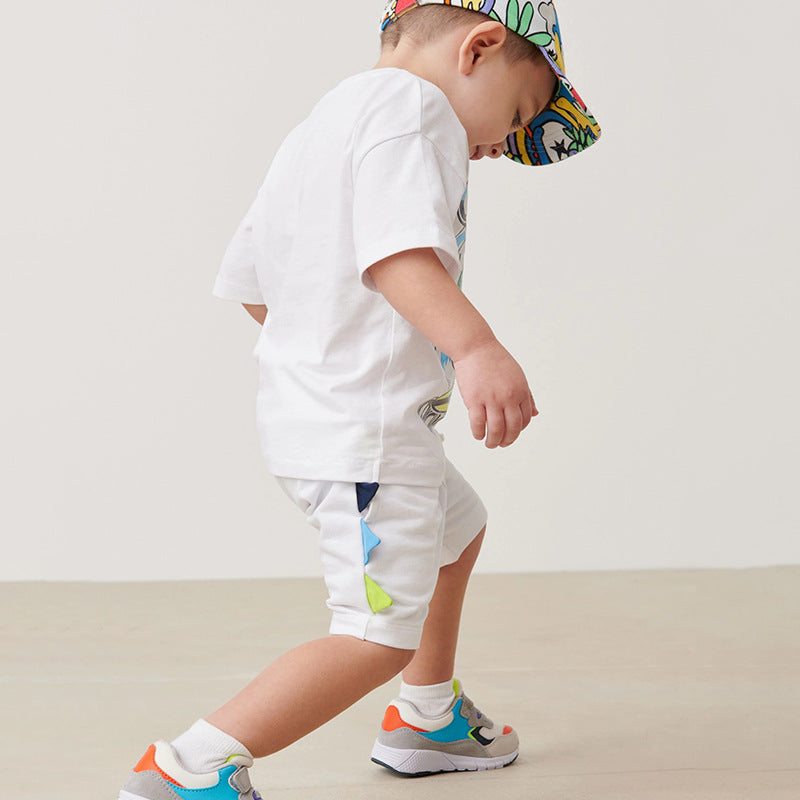 Baby boy wearing a dinosaur pattern short sleeve t-shirt clothing set, showcasing vibrant colors and playful design.