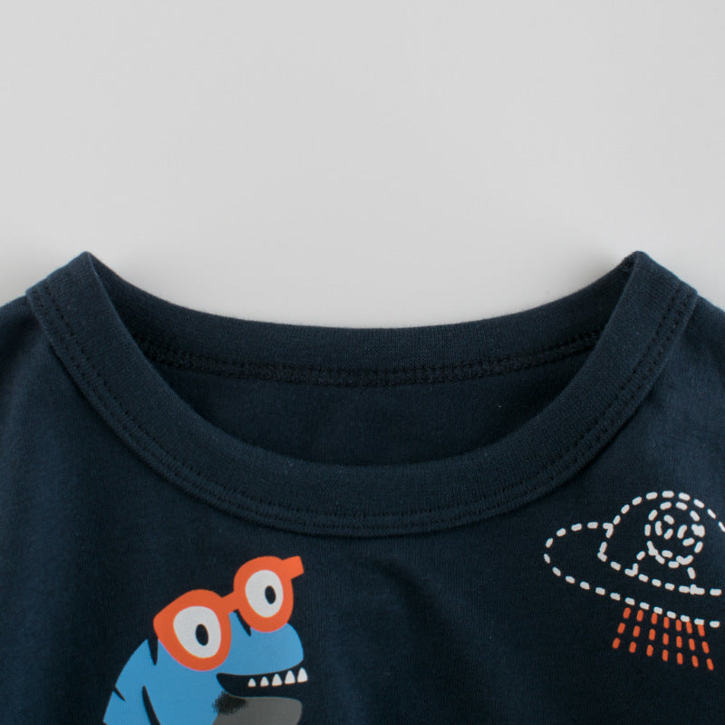 Baby boy wearing a dinosaur print round collar short-sleeved tee shirt in black, perfect for summer.