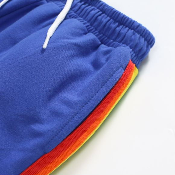 Baby boy wearing a blue hoodie with letter pattern and patchwork design, showcasing comfort and style.