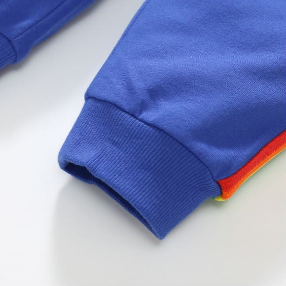 Baby boy wearing a blue hoodie with letter pattern and patchwork design, showcasing comfort and style.