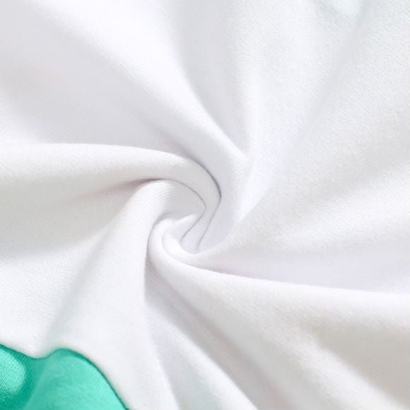 Baby boy wearing a blue hoodie with letter pattern and patchwork design, showcasing comfort and style.