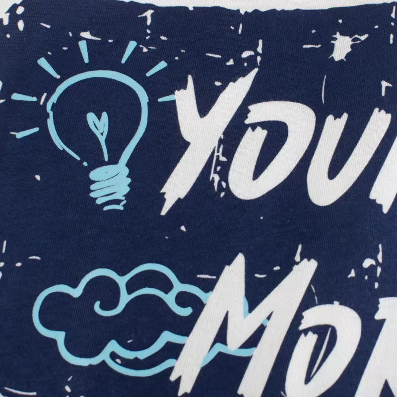 Baby boy wearing a white letter print round neck cotton top, perfect for summer.