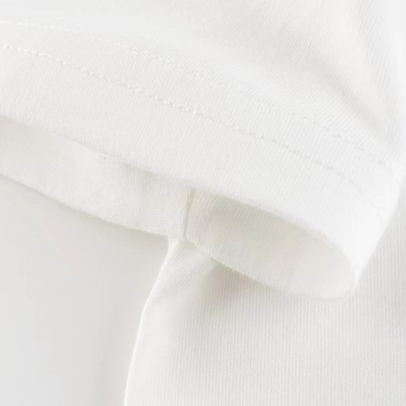 Baby boy wearing a white letter print round neck cotton top, perfect for summer.