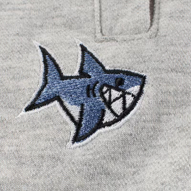 Baby boy wearing a stylish letter print round neck cotton top in green, perfect for summer outings.