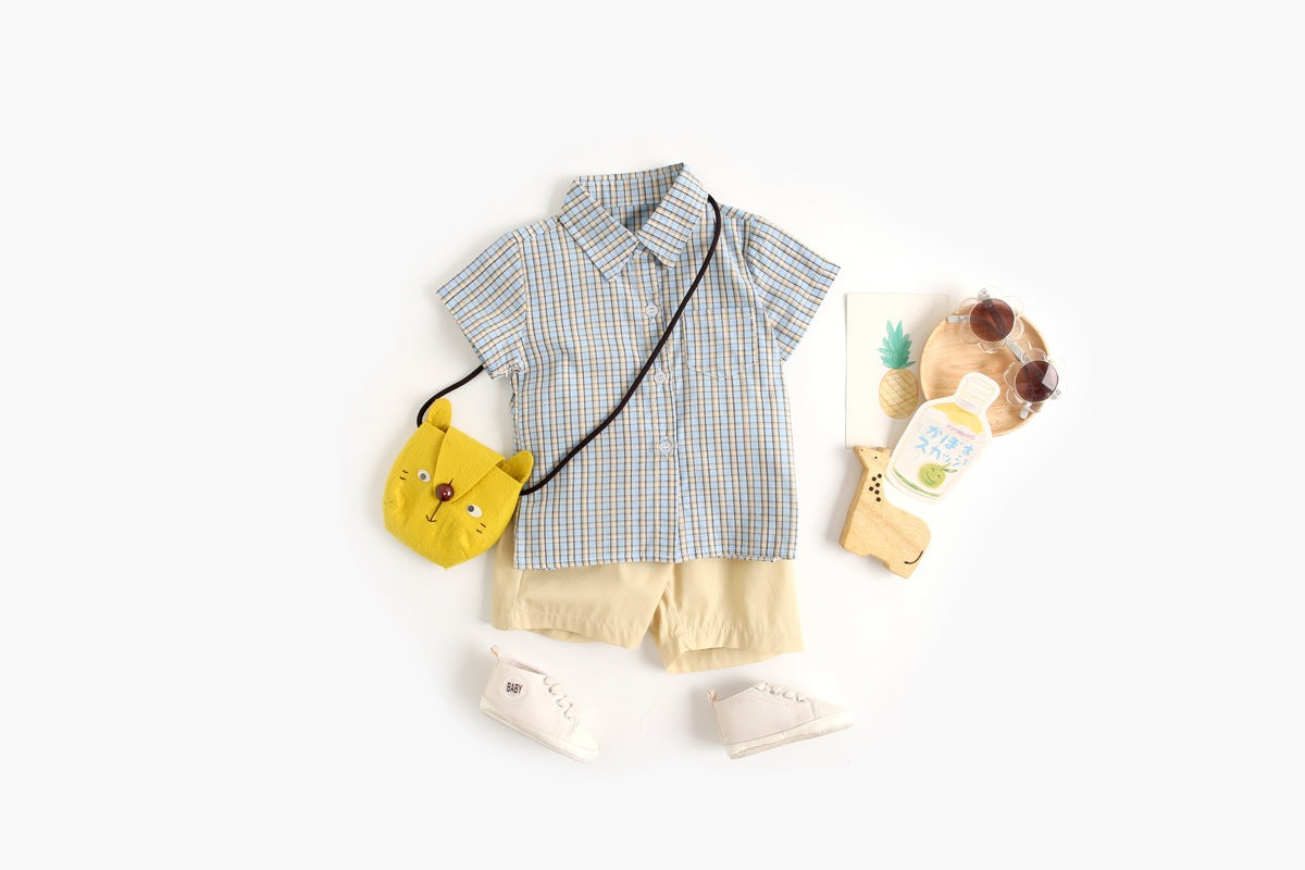 Baby boy wearing a stylish plaid pattern polo-neck shirt and shorts combo in vibrant colors.