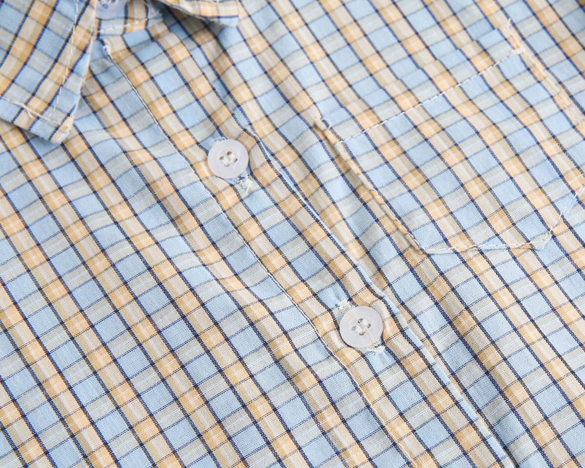 Baby boy wearing a stylish plaid pattern polo-neck shirt and shorts combo in vibrant colors.