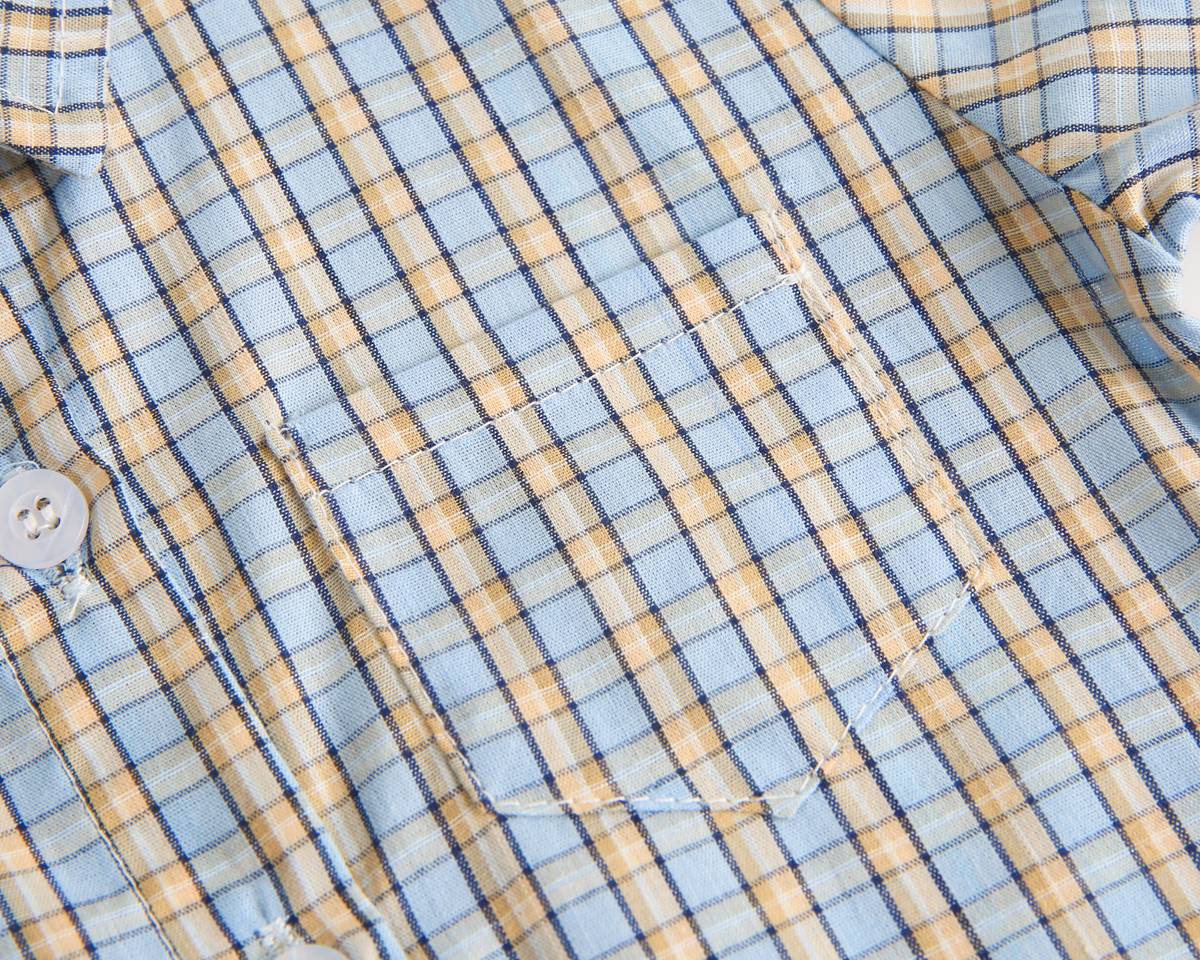 Baby boy wearing a stylish plaid pattern polo-neck shirt and shorts combo in vibrant colors.