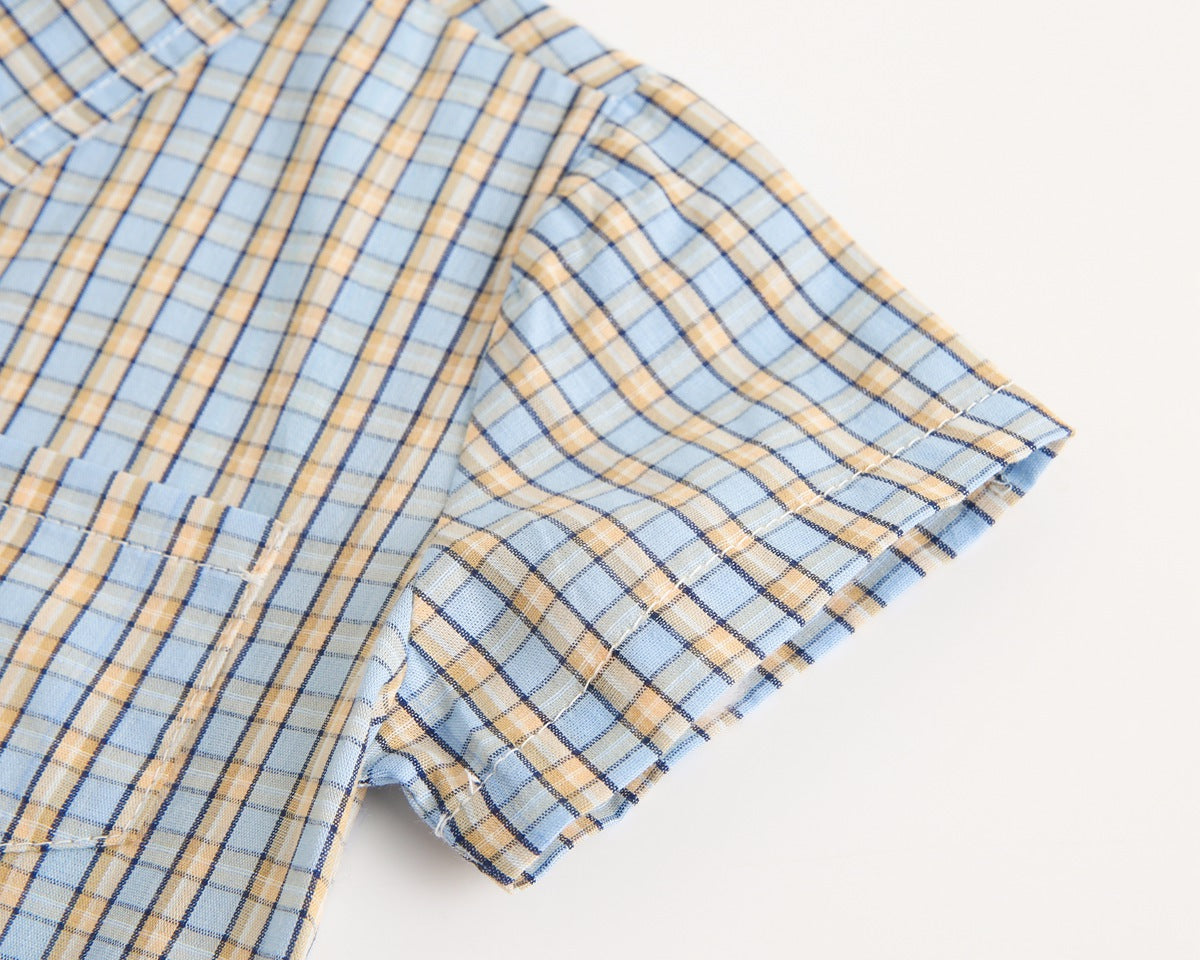 Baby boy wearing a stylish plaid pattern polo-neck shirt and shorts combo in vibrant colors.