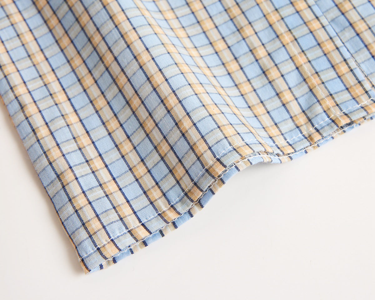 Baby boy wearing a stylish plaid pattern polo-neck shirt and shorts combo in vibrant colors.