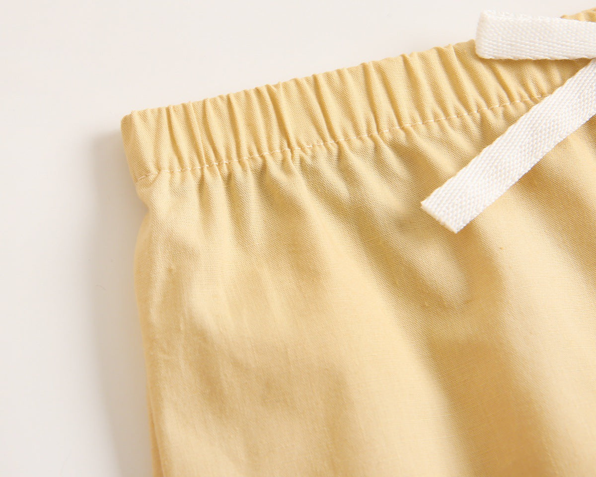 Baby boy wearing a stylish plaid pattern polo-neck shirt and shorts combo in vibrant colors.