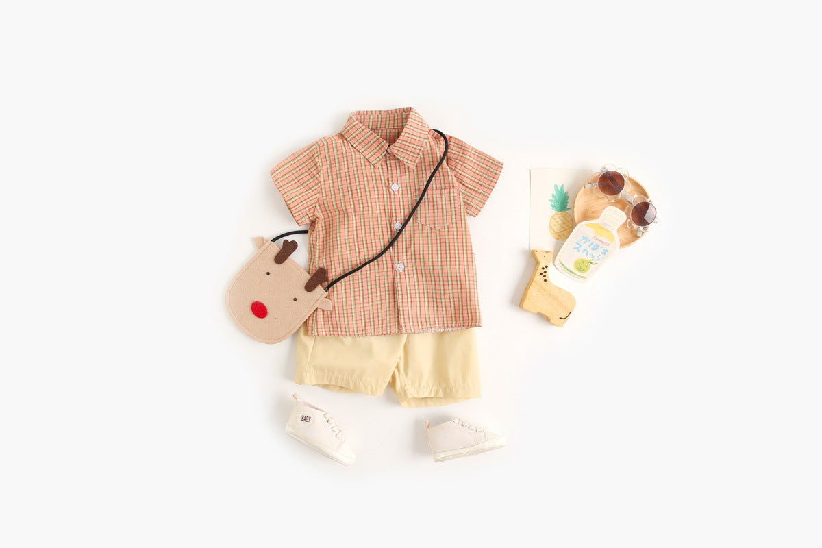 Baby boy wearing a stylish plaid pattern polo-neck shirt and shorts combo in vibrant colors.