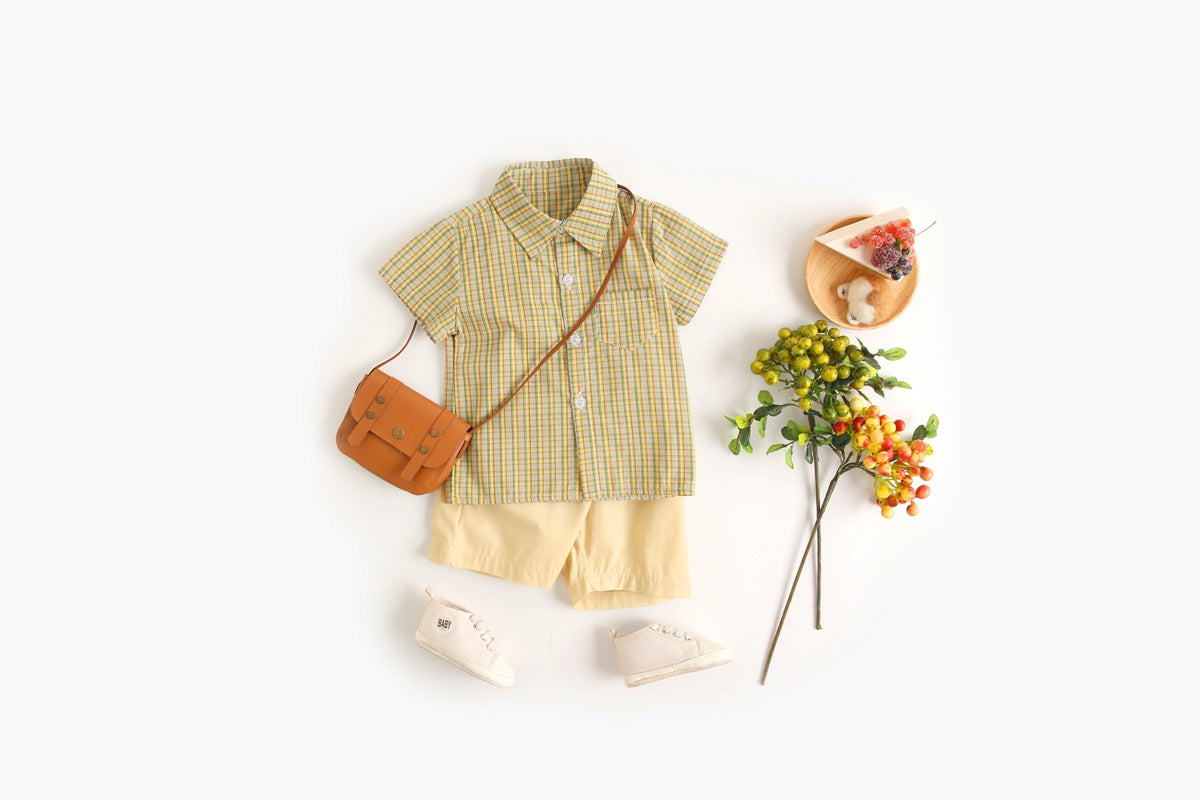 Baby boy wearing a stylish plaid pattern polo-neck shirt and shorts combo in vibrant colors.