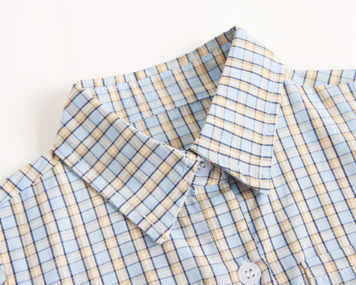 Baby boy wearing a stylish plaid pattern polo-neck shirt and shorts combo in vibrant colors.