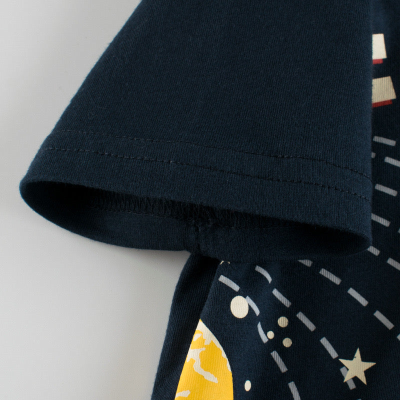 Baby boy wearing a black planet print short-sleeved t-shirt, perfect for summer outings.