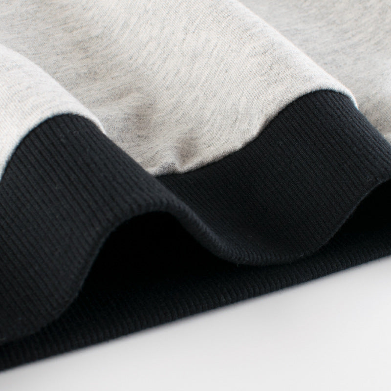 A grey baby boy pullover featuring a side striped pattern in contrasting colors, perfect for spring and autumn wear.