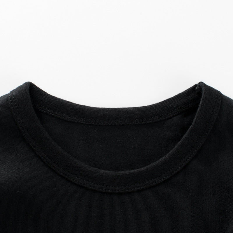 Baby boy wearing a stylish black slogan print round collar shirt with a false design, perfect for casual outings.