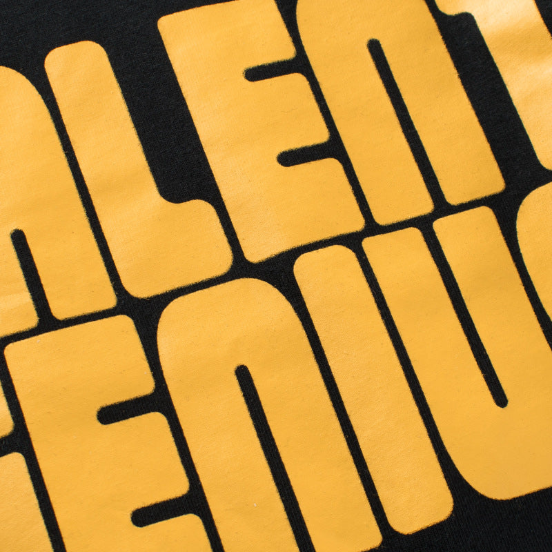 Baby boy wearing a stylish black slogan print round collar shirt with a false design, perfect for casual outings.