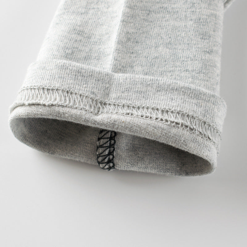 Baby boy wearing a stylish black slogan print round collar shirt with a false design, perfect for casual outings.