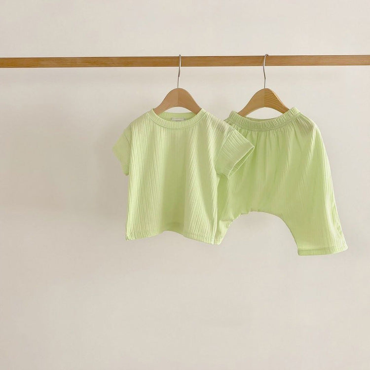 Baby boys and girls solid color round neck short-sleeved top combo in black, pink, green, and apricot, made of 100% cotton for comfort.