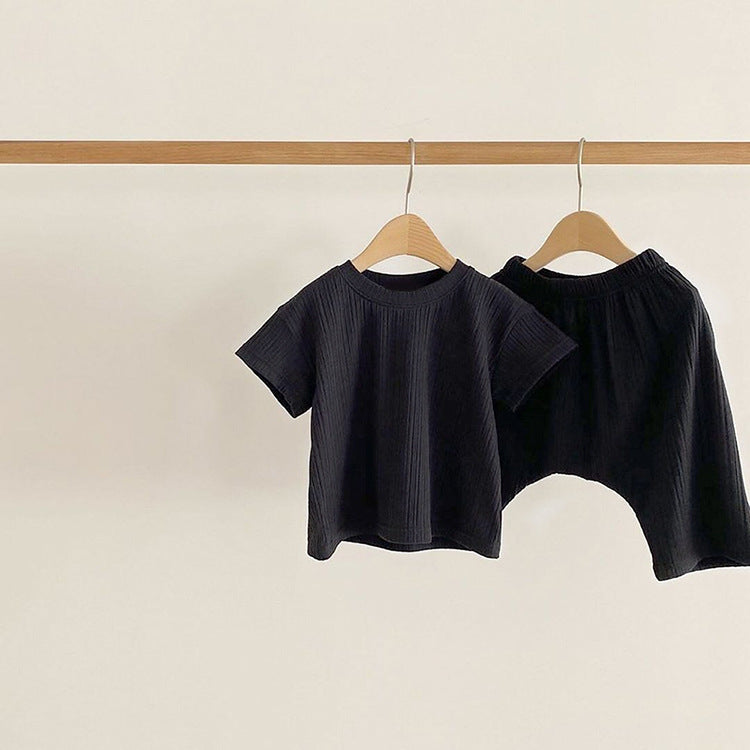 Baby boys and girls solid color round neck short-sleeved top combo in black, pink, green, and apricot, made of 100% cotton for comfort.