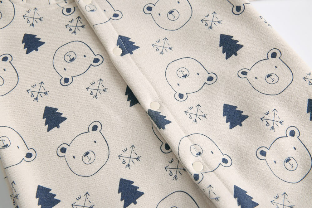 Baby wearing a cute cartoon animal romper with a matching hat, showcasing a playful design in yellow and khaki colors.