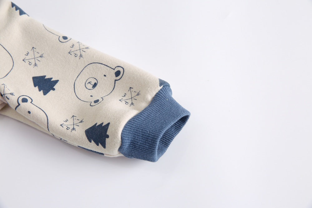 Baby wearing a cute cartoon animal romper with a matching hat, showcasing a playful design in yellow and khaki colors.