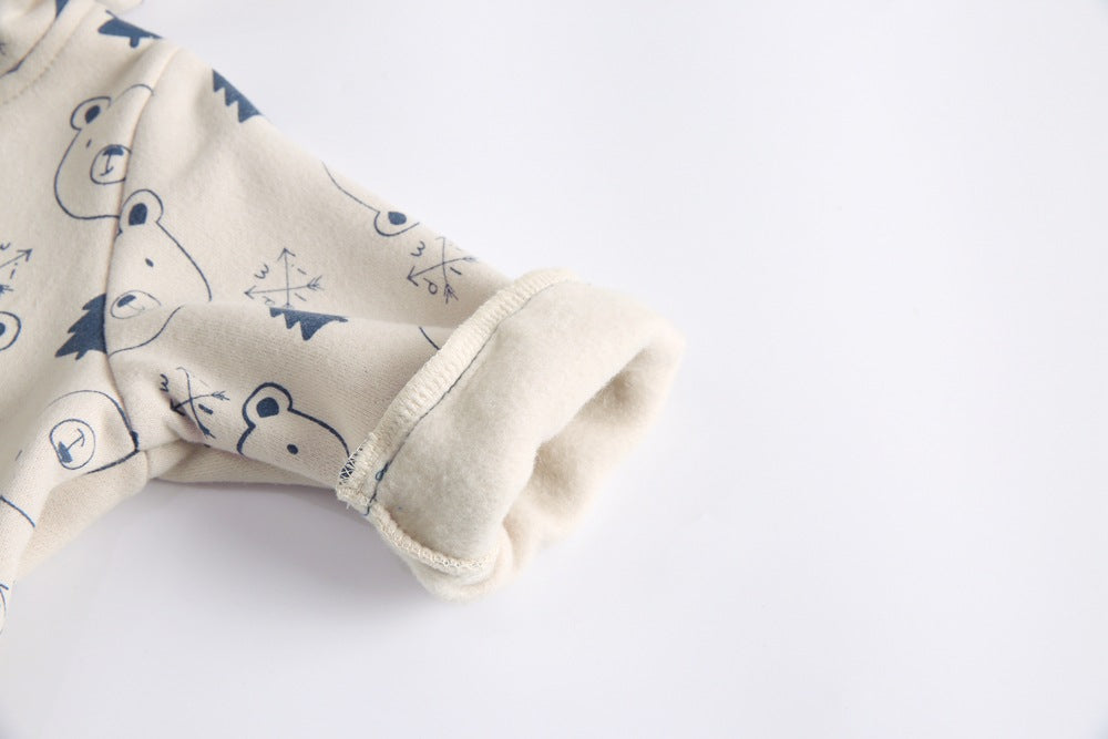 Baby wearing a cute cartoon animal romper with a matching hat, showcasing a playful design in yellow and khaki colors.