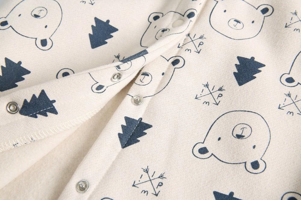 Baby wearing a cute cartoon animal romper with a matching hat, showcasing a playful design in yellow and khaki colors.