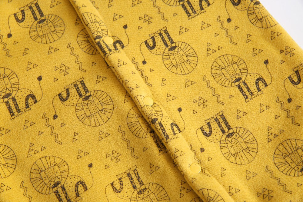 Baby wearing a cute cartoon animal romper with a matching hat, showcasing a playful design in yellow and khaki colors.