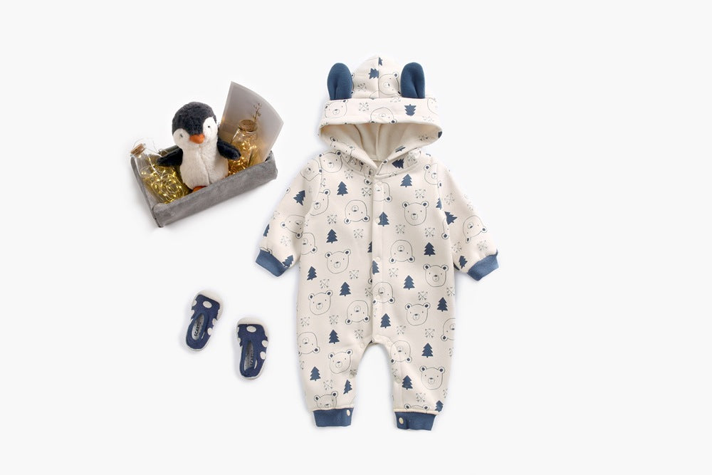 Baby wearing a cute cartoon animal romper with a matching hat, showcasing a playful design in yellow and khaki colors.