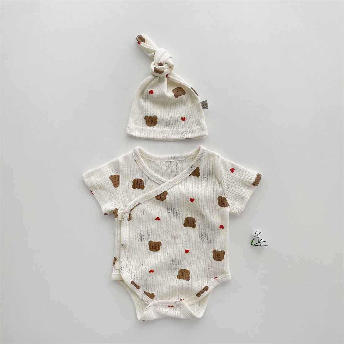 Baby girl wearing a soft cotton onesie with cartoon animal graphics in a vibrant color.