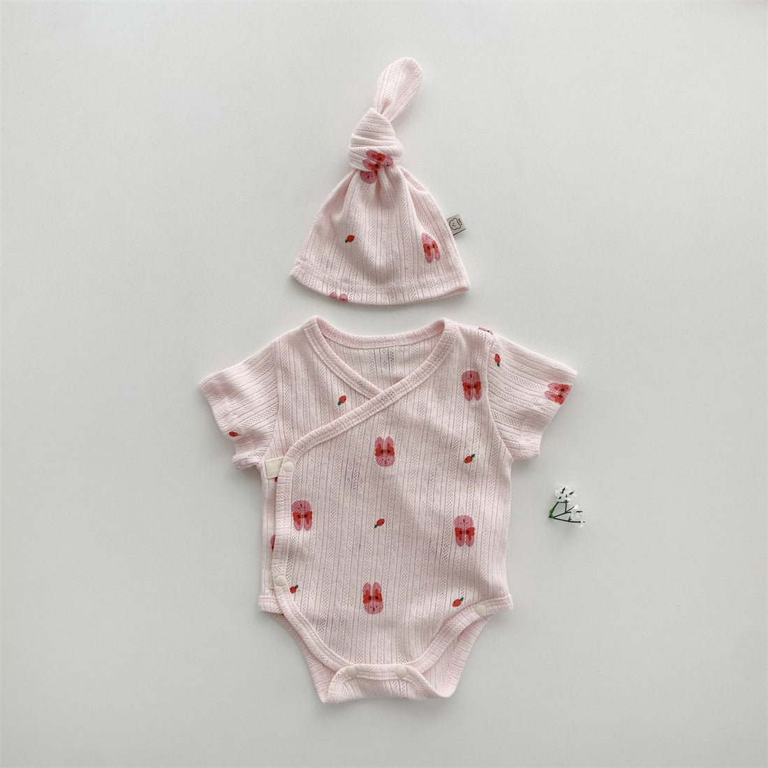 Baby girl wearing a soft cotton onesie with cartoon animal graphics in a vibrant color.