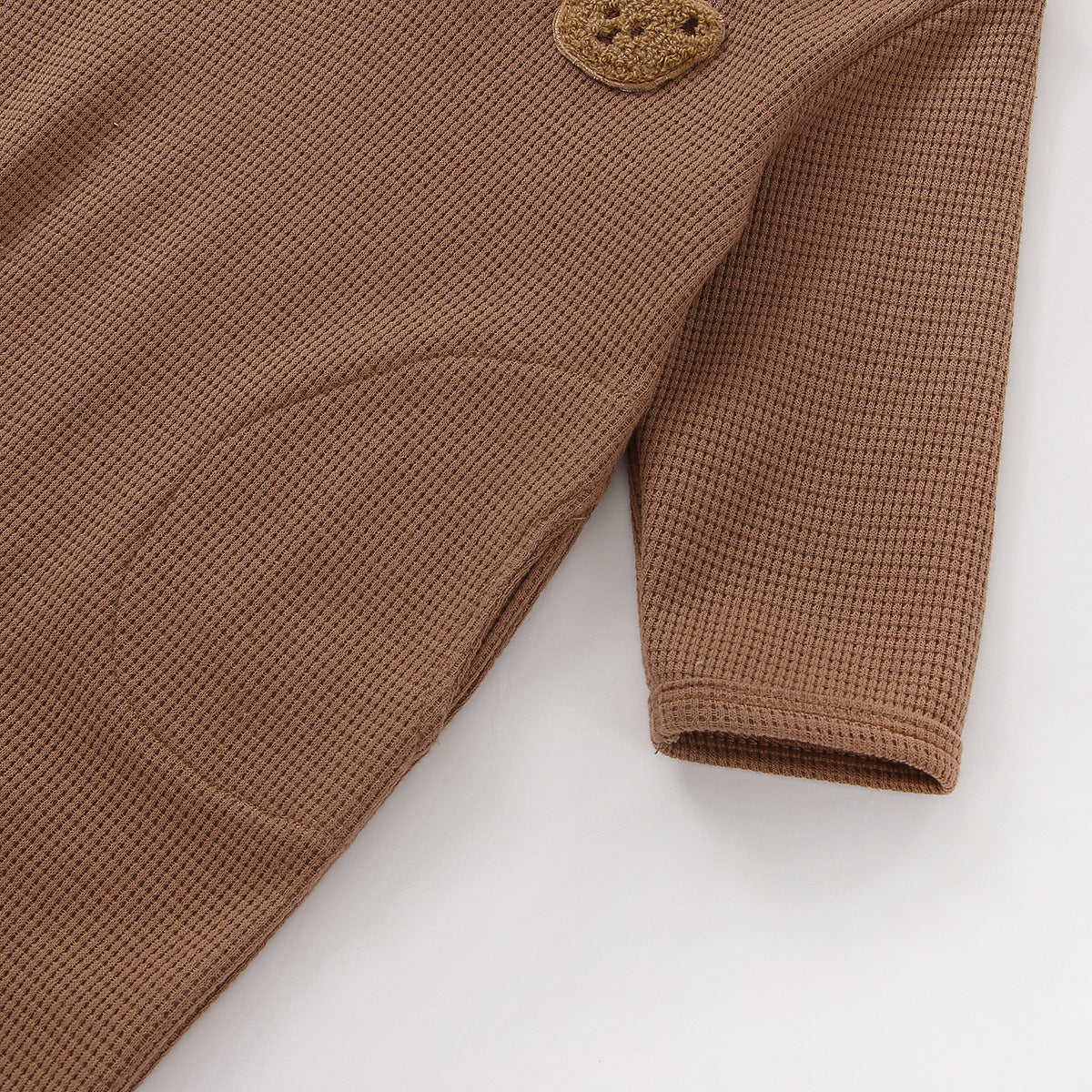 Baby Cartoon Bear Embroidered Pattern Long Sleeve Romper in apricot and brown colors, made from soft waffle fabric.
