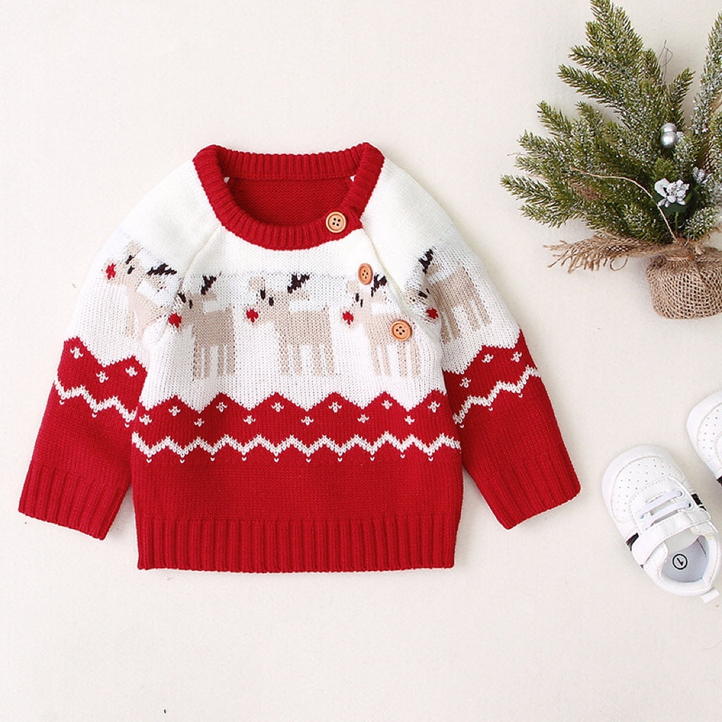 A cozy knitted baby sweater featuring a cartoon deer pattern and shoulder button design, available in red and navy blue.