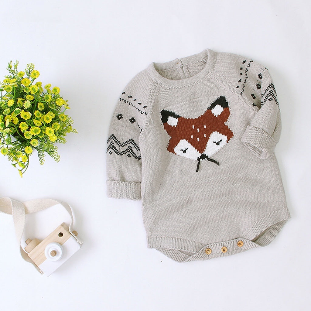 Baby wearing a cute cartoon fox graphic romper with long sleeves, featuring a triangle knitted design in blue and grey colors.
