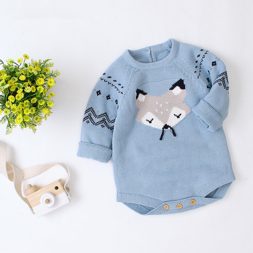 Baby wearing a cute cartoon fox graphic romper with long sleeves, featuring a triangle knitted design in blue and grey colors.