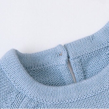 Baby wearing a cute cartoon fox graphic romper with long sleeves, featuring a triangle knitted design in blue and grey colors.