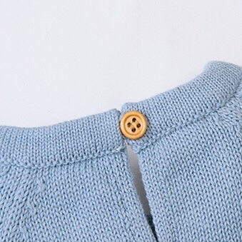 Baby wearing a cute cartoon fox graphic romper with long sleeves, featuring a triangle knitted design in blue and grey colors.