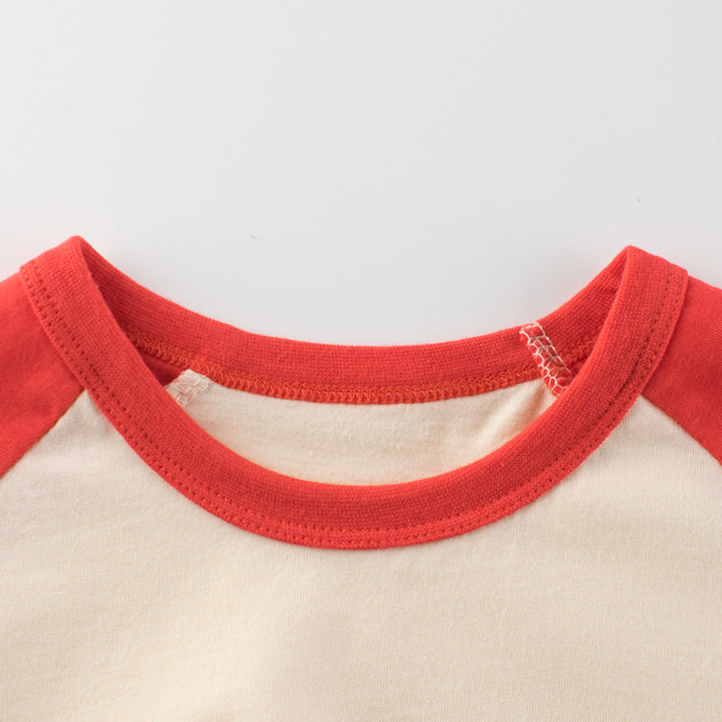 A vibrant red baby top featuring a cute cartoon graphic, perfect for summer wear.