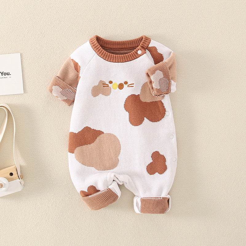 A stylish baby jumpsuit featuring a handknit design with cute cartoon graphics, perfect for infants.