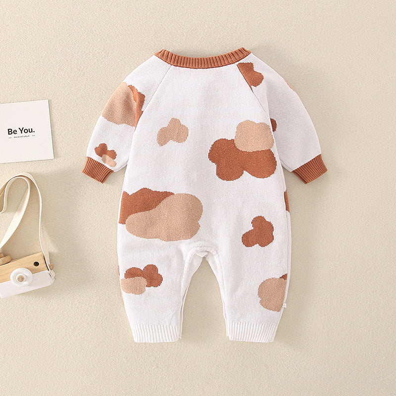A stylish baby jumpsuit featuring a handknit design with cute cartoon graphics, perfect for infants.