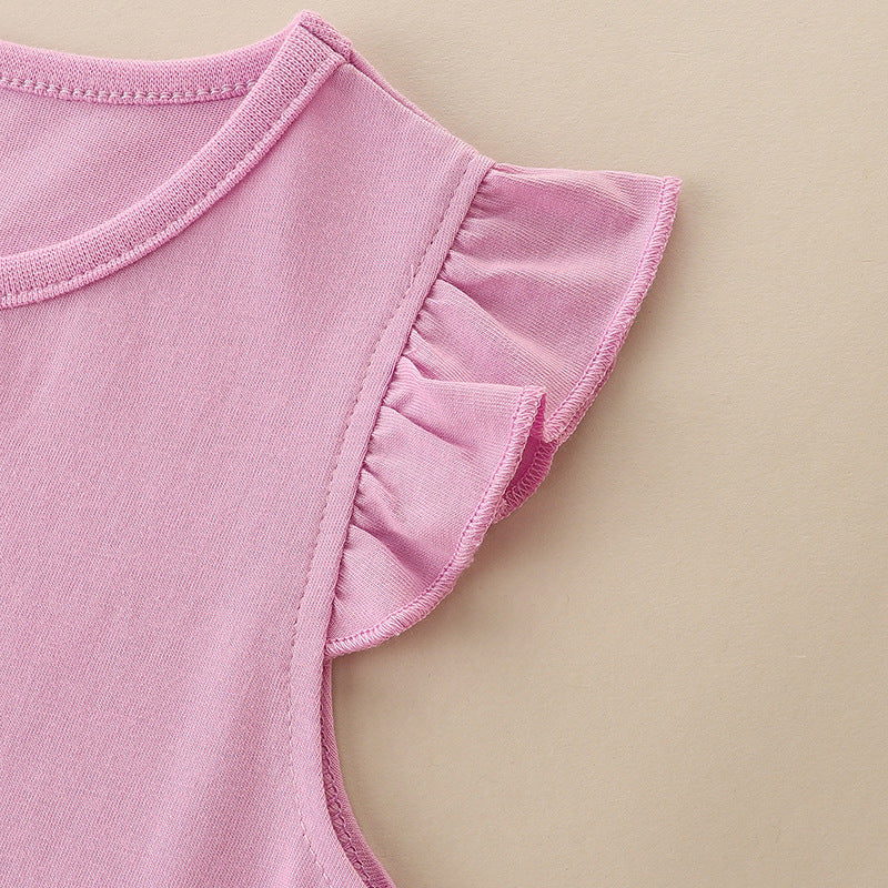 A cute baby girl wearing a pink sleeveless summer dress with cartoon patches, perfect for summer outings.