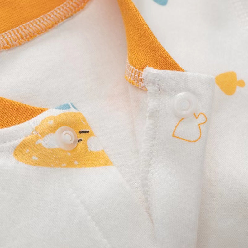 A colorful baby romper featuring a cartoon pattern, button front design, and long sleeves, made from soft cotton fabric.