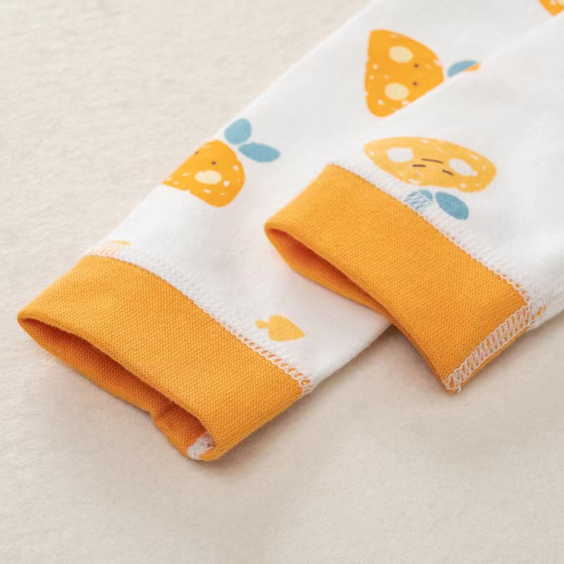 A colorful baby romper featuring a cartoon pattern, button front design, and long sleeves, made from soft cotton fabric.