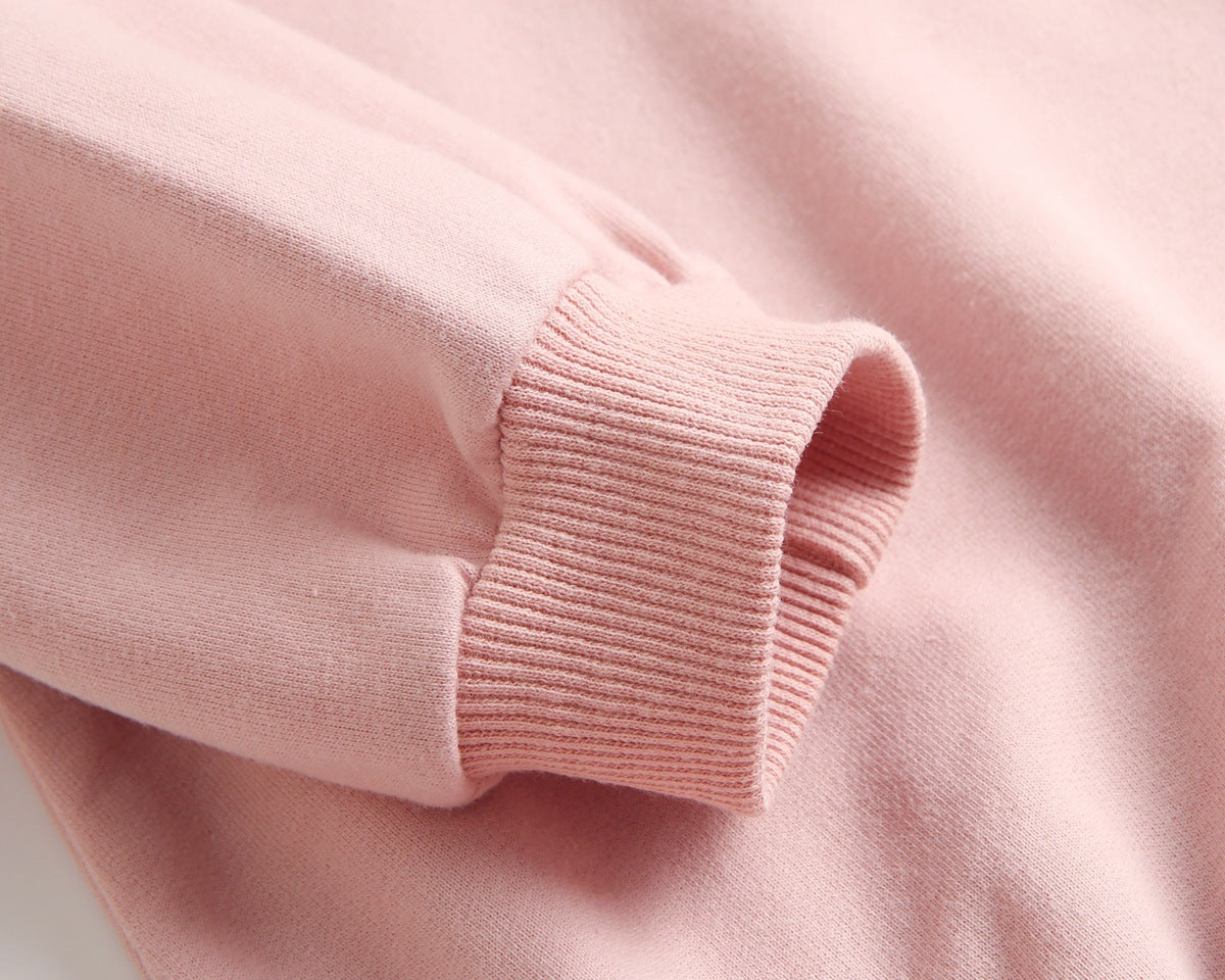 Bright and cozy baby onesie featuring a playful cartoon pattern and a matching hat, perfect for stylish comfort.