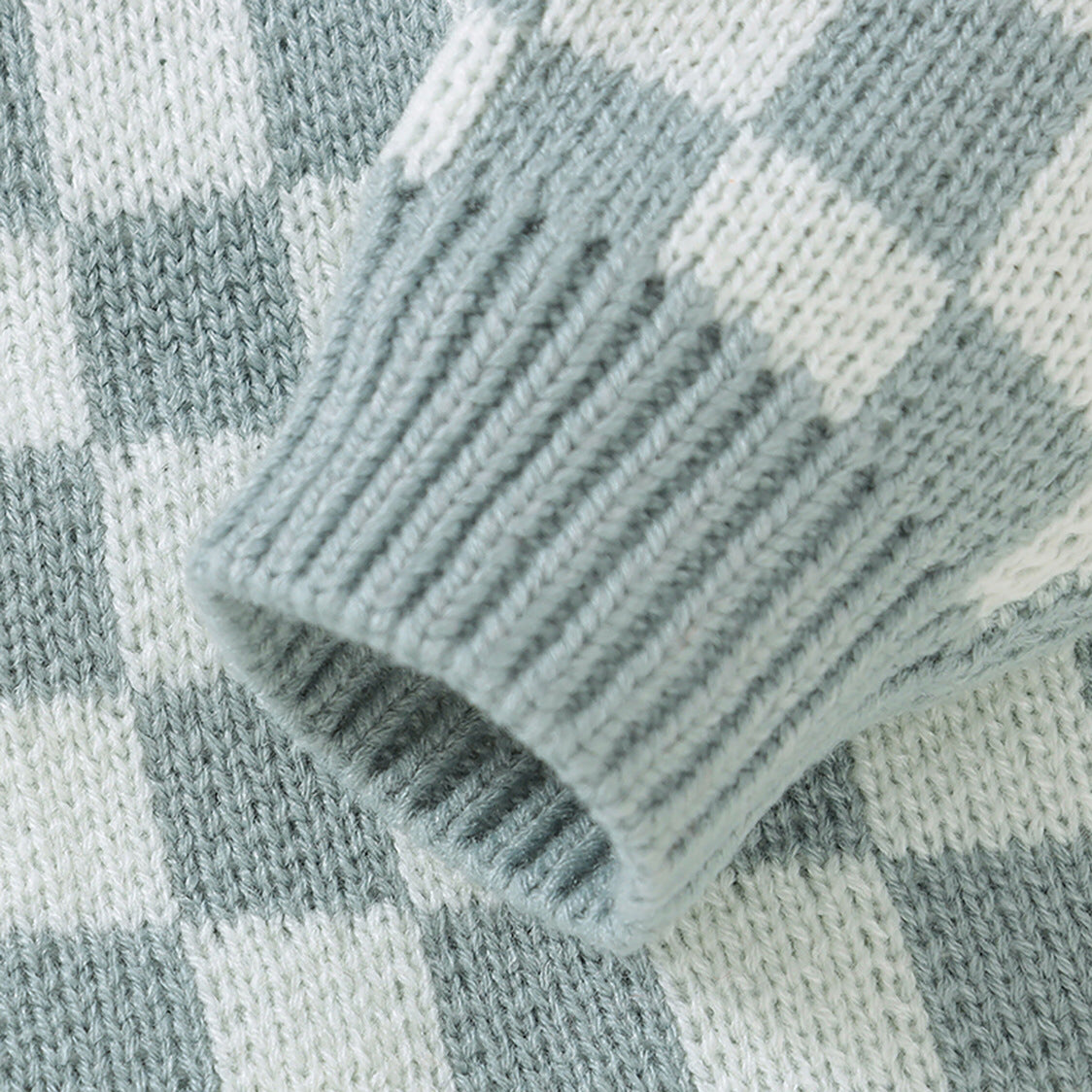 A stylish Baby Checkerboard Pattern Quality Knit Onesie in black, pink, and blue, showcasing its soft cotton fabric and trendy plaid design.