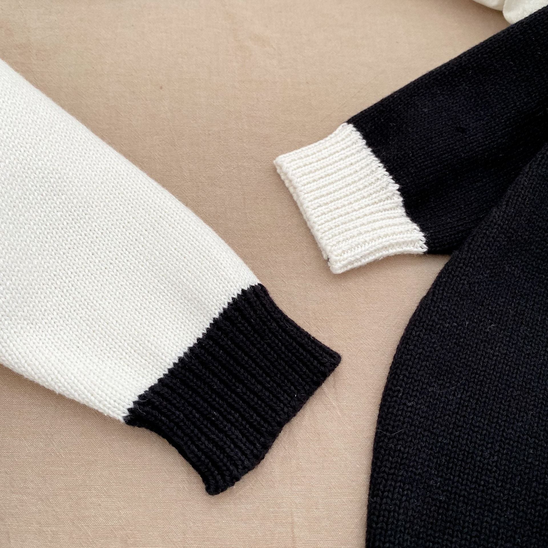 Baby girl wearing a stylish sleeveless onesie with a matching cardigan, showcasing a color matching design in soft cotton fabric.