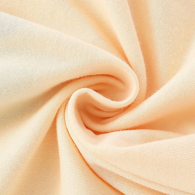 Baby wearing a cute pattern solid color long sleeve shirt in apricot, perfect for spring and autumn.