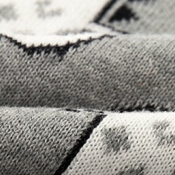 Baby romper featuring a playful dinosaur and pineapple pattern with shoulder button design, made from soft cotton fabric.